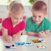 two happy children playing with dices