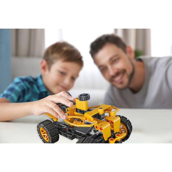 little boy and father playing with car on table at home