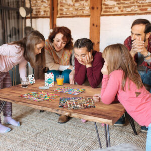 happy family at home in the couch playing classic table games