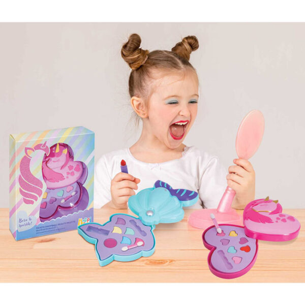 happy young girl puts lipstick on her lips looking in the mirror