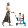 full length profile shot of a mother pushing a girl on a tricycl