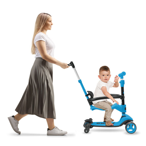 full length profile shot of a mother pushing a girl on a tricycl