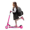 schoolgirl with a backpack riding a scooter