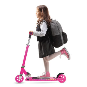 schoolgirl with a backpack riding a scooter