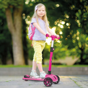 little child learning to ride a scooter in a city park on sunny summer day. cute preschooler girl in safety helmet riding a roller. kids play outdoors. active leisure and outdoor sport for children.